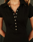 Luxury Western Golf apparel Black dress with silver buttons worn by a person against a dark background