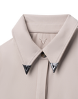 Luxury Western Golf apparel Close-up of a light gray coat with a collar and decorative buttons on a white background