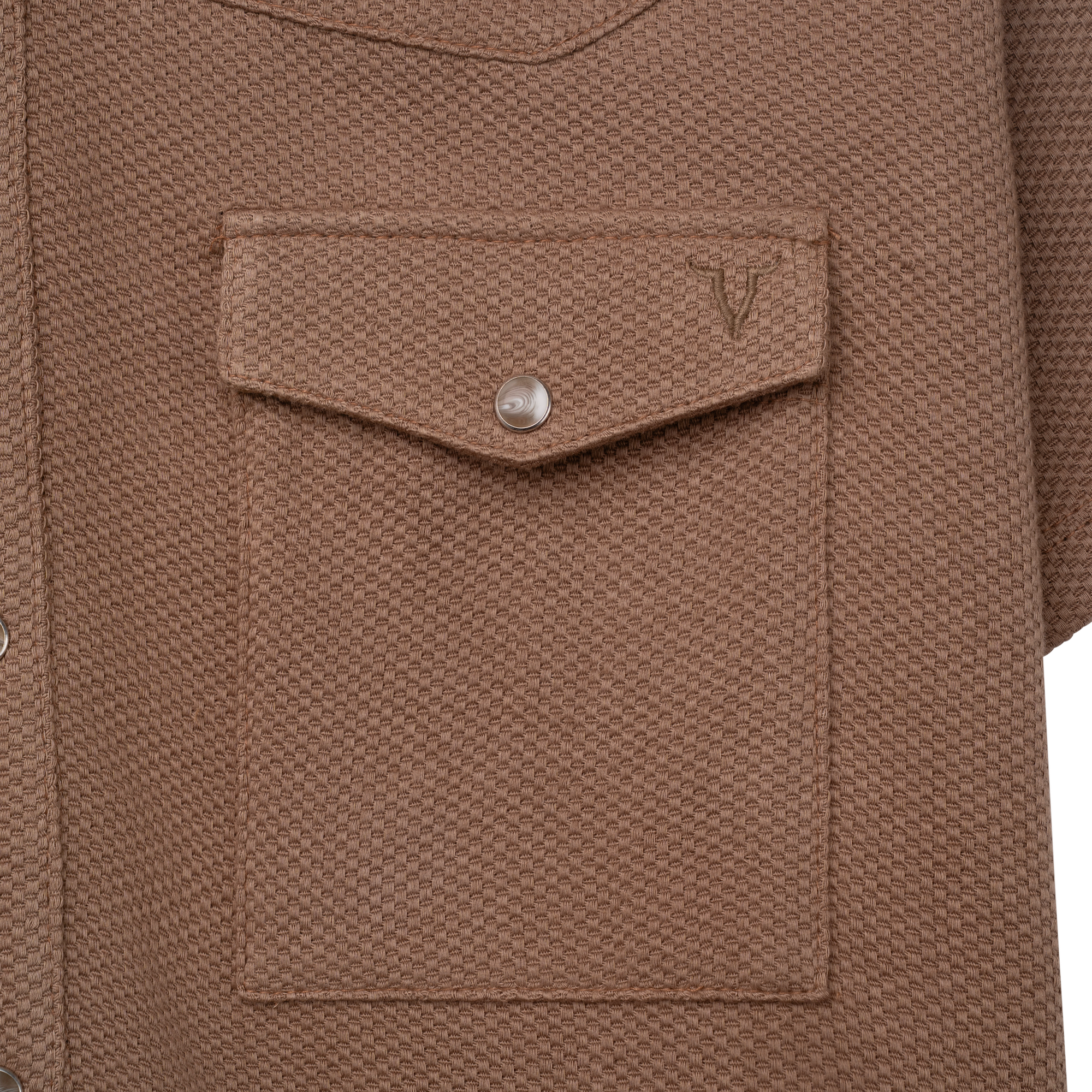 Luxury Western Golf apparel Close-up of a brown textured shirt with a pocket and button on a white background