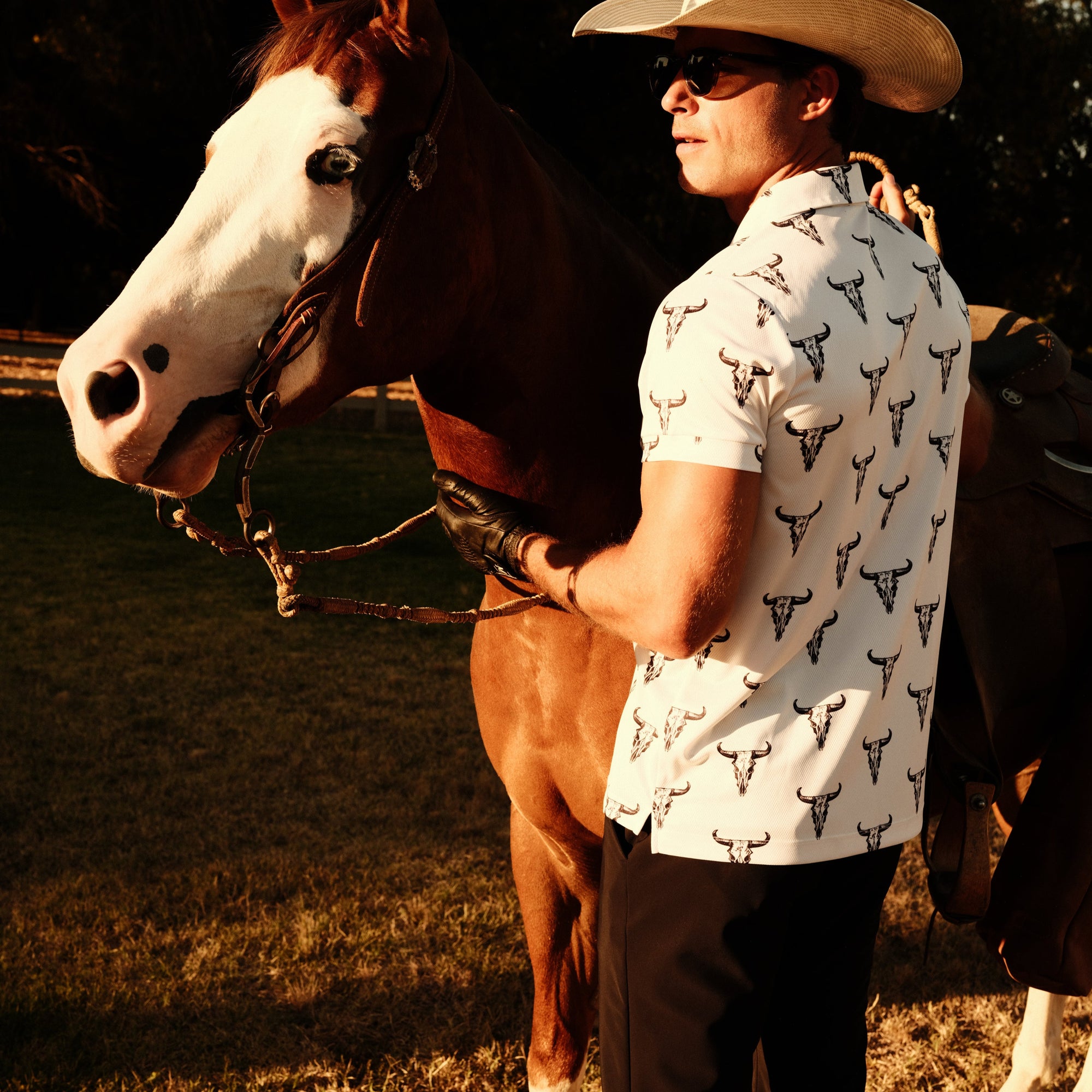 Luxury Western Golf apparel Man in a cowboy hat standing next to a horse in a field